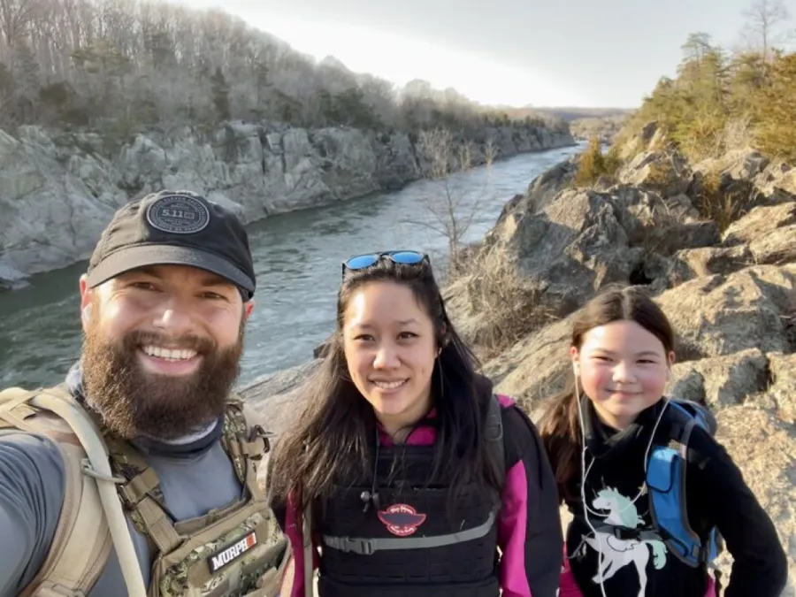 Vadim Snitkovsky hiking with his family on a ridge above a river gorge